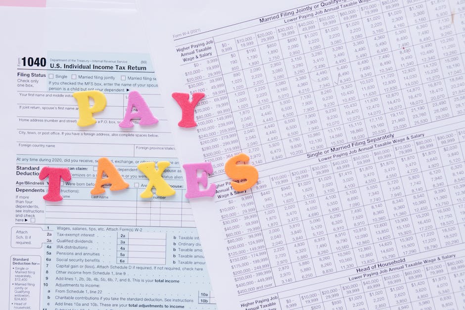 A woman using a pink calculator surrounded by bills and receipts at a desk.