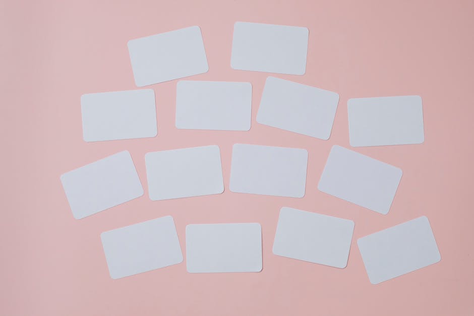 Empty rectangular paper sheets with rounded edges chaotically attached on light pink background
